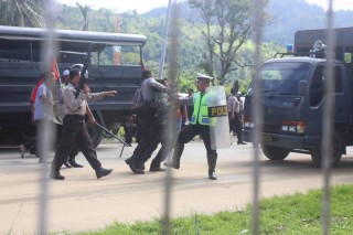 West Papuan man being arrested and beaten by armed Indonesian police in Port Numbay/Jayapura. 28th May 2015
